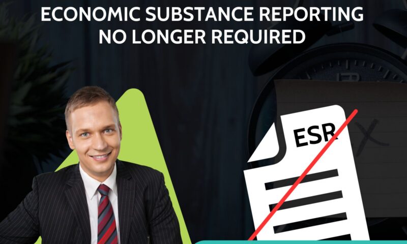 Smiling businessman in pinstripe suit at a desk beside an ESR document graphic with red strike-through, captioned update, Economic Substance Reporting no longer required