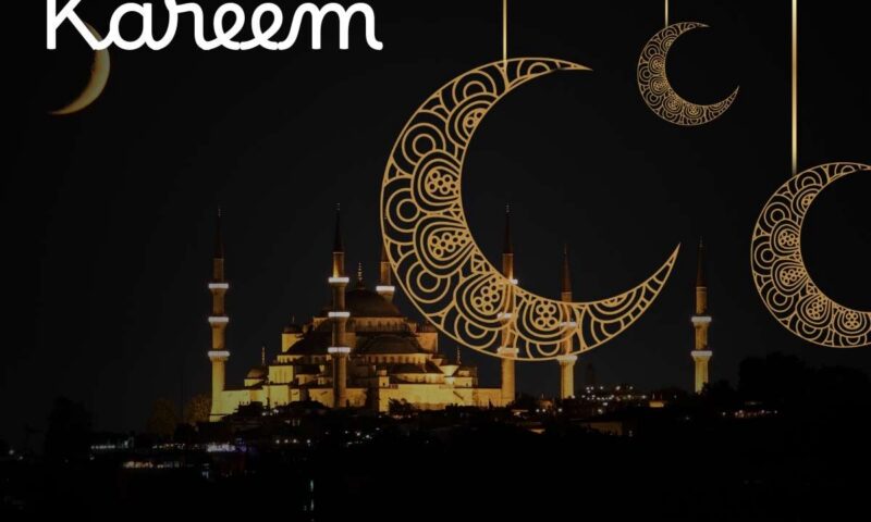 Decorative gold filigree crescent moons over a silhouetted mosque at night, captioned Ramadan Kareem